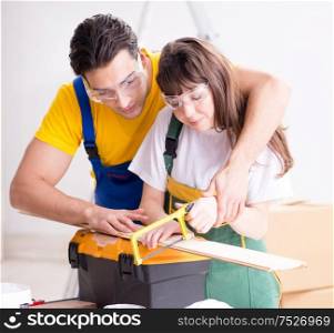 Man explaining woman woodworking tips in wood workshop. The man explaining woman woodworking tips in wood workshop
