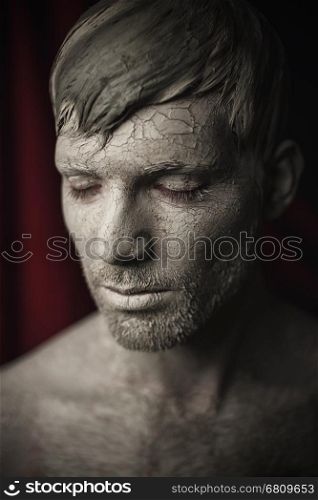 Man Face with Skin Covered in Mud. Portrait of Young Men with Skin Covered in Mud.