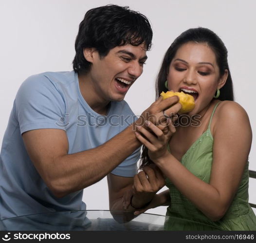 Man feeding a woman