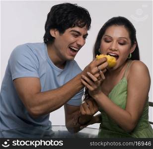 Man feeding a woman