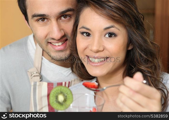 Man feeding his girlfriend strawberries