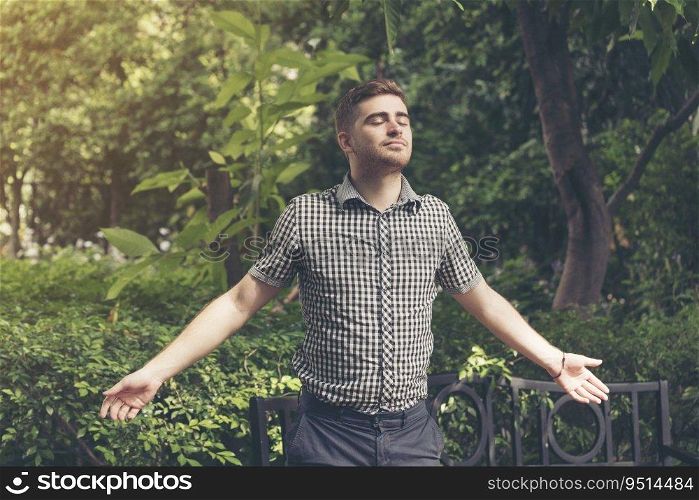 Man feeling relax while enjoy freedom in the park. Relaxation lifestyle concept.