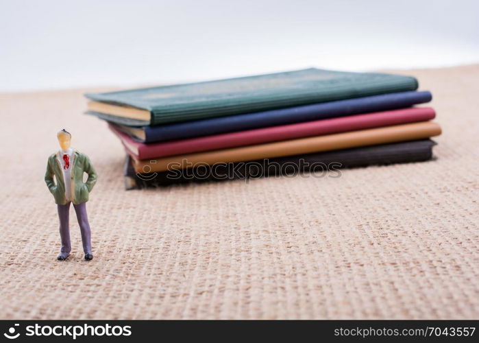 Man figurine standing inside the pages of the book