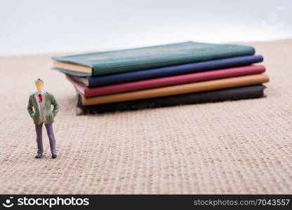 Man figurine standing inside the pages of the book