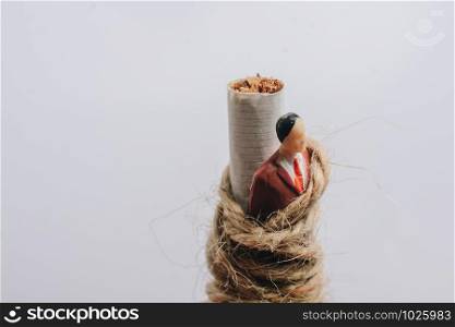 Man figurine tied to a cigarette as anti smoking concept