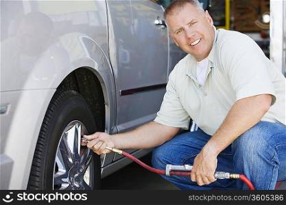 Man Filling Tires on RV
