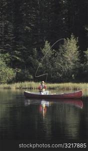 Man Fishing in Canoe