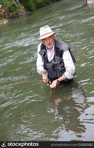 Man fishing trout in river