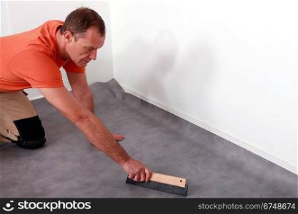 Man fitting a lino floor
