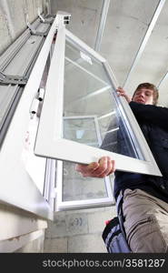 Man fitting a window