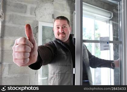 Man fitting a window giving you the thumbs up