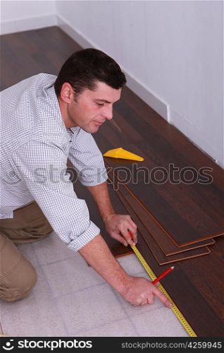 Man fitting a wooden floor