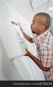 Man fixing a wall device