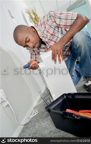 Man fixing an air conditioning unit