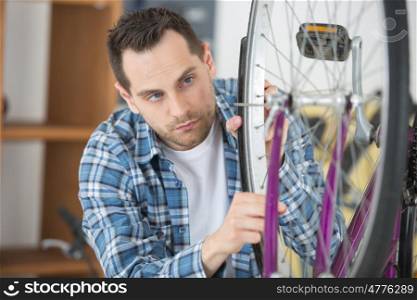 man fixing bicycle tyre