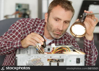 man fixing computer by putting cpu on socket