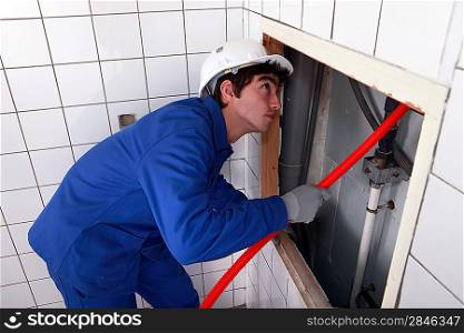 man fixing plumbing
