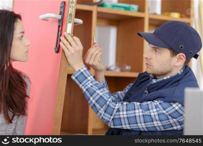 man fixing the door with screwdriver