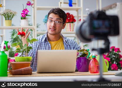 Man florist gardener vlogger blogger shooting video on camera