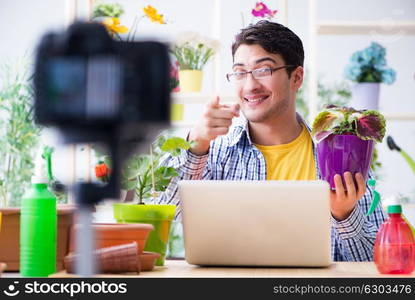 Man florist gardener vlogger blogger shooting video on camera