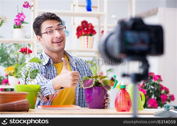 Man florist gardener vlogger blogger shooting video on camera
