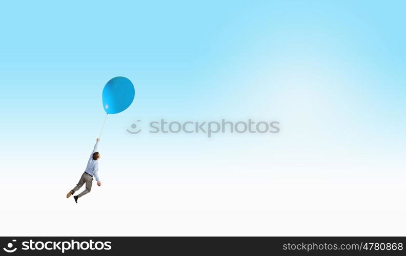 Man flying in sky. Young successful businessman flies on colorful balloon