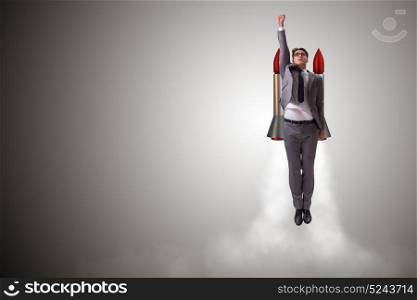 Man flying with the rocket in business concept