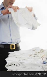 man folding white cloth
