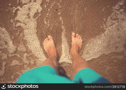 Man foots at seashore