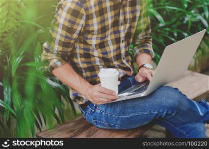 man freelance / college student using laptop at a outdoor