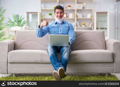 Man freelancer in a cervical collar neck brace working from home