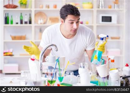 Man frustrated at having to wash dishes