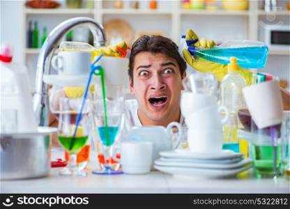 Man frustrated at having to wash dishes. The man frustrated at having to wash dishes