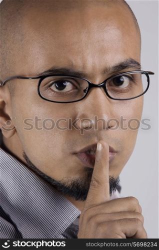 Man gesturing to be quiet