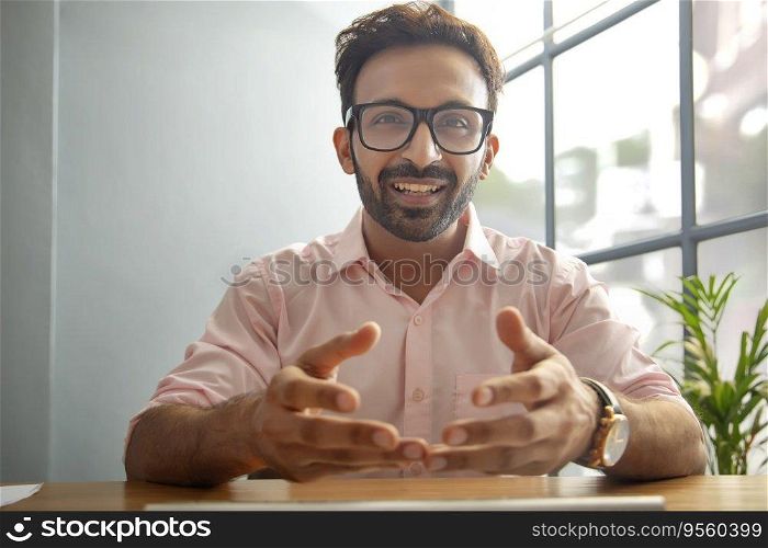 Man gesturing while talking on video call