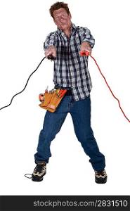 Man getting an electric shock from jump leads