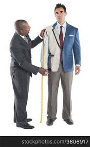 Man getting measured by a tailor on a white background