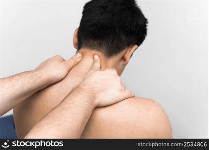 man getting neck massage pain from physiotherapist