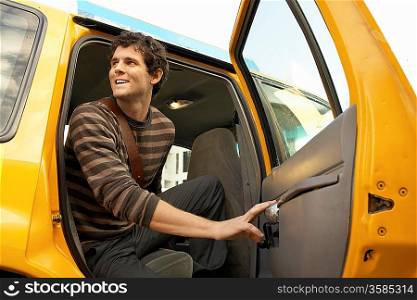 Man Getting Out of Taxi