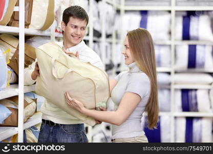 Man gives a girl the pillow in the store