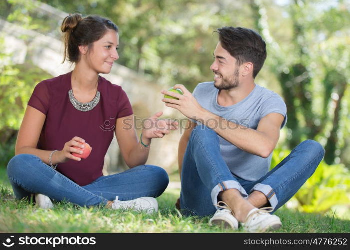 man gives woman an apple - dating concept