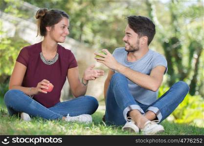 man gives woman an apple - dating concept