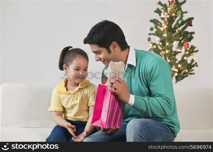 Man giving daughter a gift