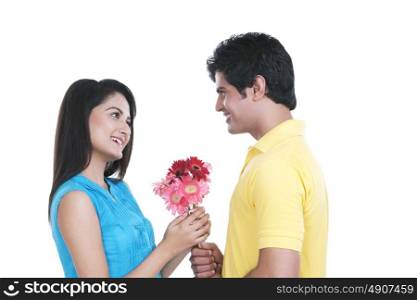 Man giving flowers to his girl friend