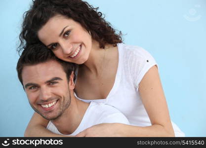 Man giving girlfriend piggy-back