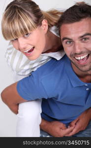 Man giving girlfriend piggyback