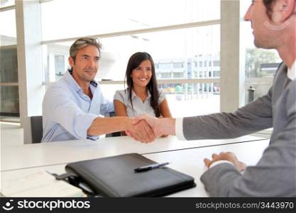 Man giving handshake to real-estate-agent