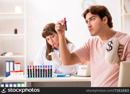 Man giving his blood as a donor. The man giving his blood as a donor