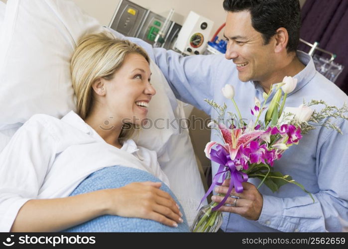 Man Giving His Pregnant Wife Flowers