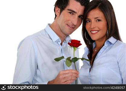 Man giving rose to woman